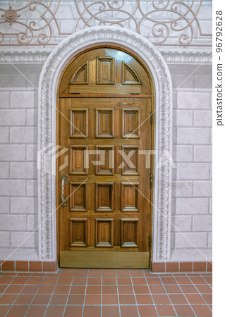 Arched door with decorative doorframe and block walls in a church at downtown Tucson, Arizona 96792628