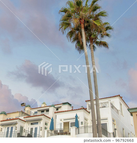 Square Puffy clouds at sunset Low angle view of mediterranean style building residences at La Square Puffy clouds at sunset Low angle view of mediterranean style building residences at La 96792668