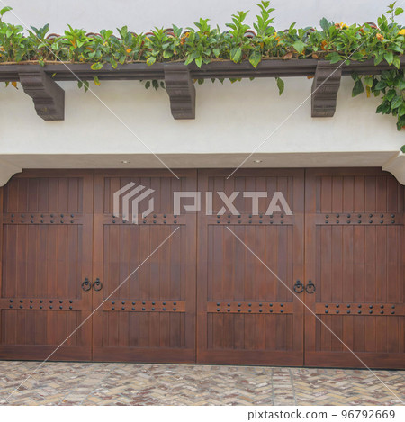 Square Dark wood side-hinged double garage doors at La Jolla, California Square Dark wood side-hinged double garage doors at La Jolla, California 96792669