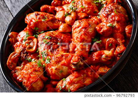 chicken stew with mushrooms in a tomato sauce 96792793