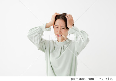Woman holding her head white background Woman holding her head white background 96793140