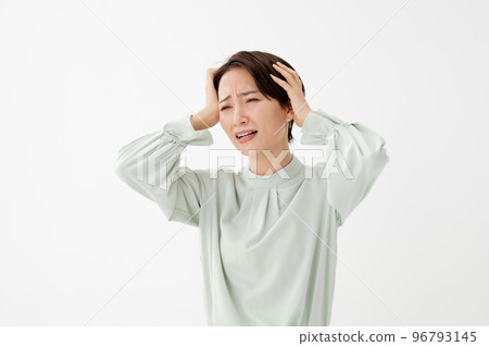 Woman holding her head white background 96793145