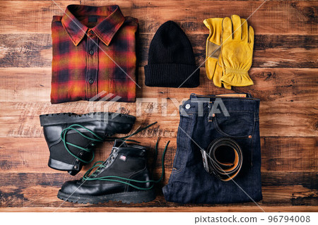 Flannel shirt and jeans on wooden table Flannel shirt and jeans on wooden table 96794008