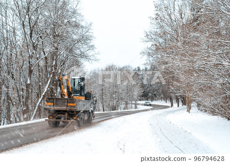 Heavy transport passing on a highway with snow slush and snow fall 96794628