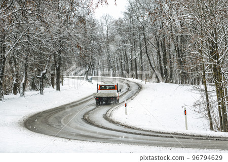 Mini truck passing on a highway with snow slush and snow fall Mini truck passing on a highway with snow slush and snow fall 96794629