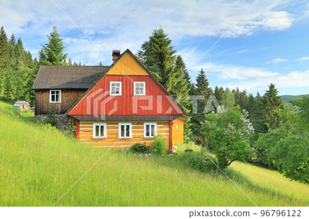 Beautiful wooden cottage on mountain meadow Beautiful wooden cottage on mountain meadow 96796122