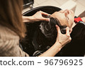 Hair salon master washing client hair at barber shop. Men's fashion and style. Hair care, beauty 96796925