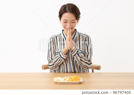 A woman eating sweets 96797400
