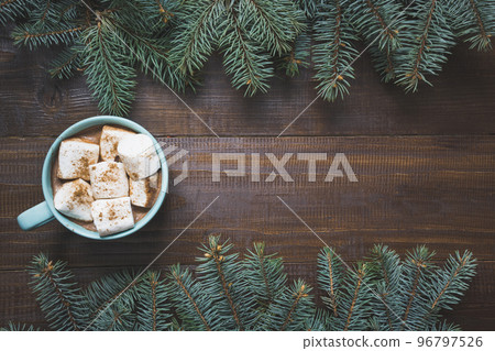 Christmas mug of hot coffee with marshmallow on wooden board. New Year. Holiday card. Rustic style. Top view and copy space. 96797526