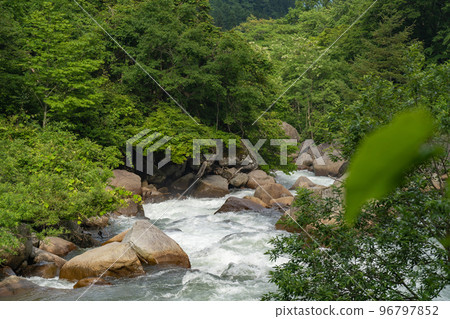 Abundant water flow from Naena Falls 96797852