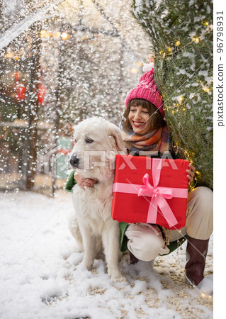 Woman with dog celebrates winter holidays 96798931