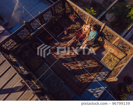Beautiful morning in Cappadocia - a young couple on the Turkish terrace Beautiful morning in Cappadocia - a young couple on the Turkish terrace 96799139