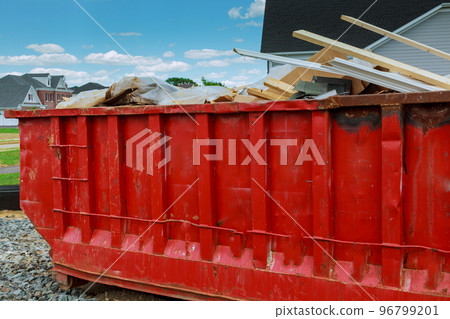 Dumpster with left over wood from construction 96799201