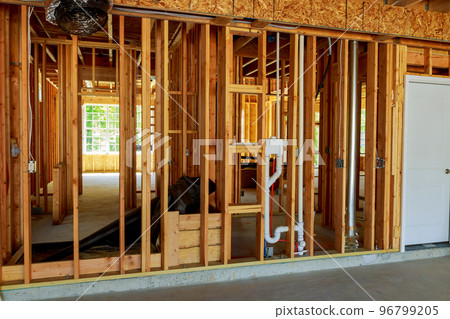 unfinished wood frame building or a house 96799205