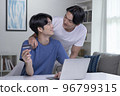 Asian gay couple holding credit card and using laptop computer 96799315