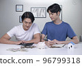 Asian gay couple saving money to buy a house 96799318