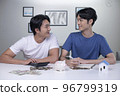 Asian gay couple saving money to buy a house. 96799319