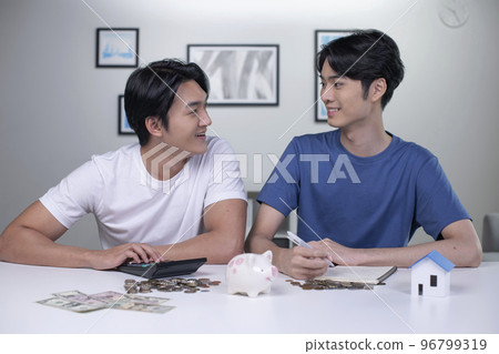 Asian gay couple saving money to buy a house. Asian gay couple saving money to buy a house. 96799319