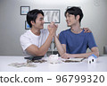 Asian gay couple saving money to buy a house 96799320