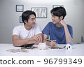 Asian gay couple saving money to buy a house 96799349