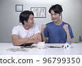 Asian gay couple saving money to buy a house 96799350