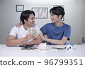 Asian gay couple saving money to buy a house 96799351