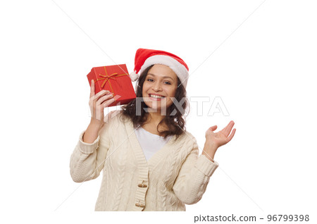 Latin American beautiful woman in Santa hat with Xmas gift box, smiling a toothy smile looking at camera, isolated on white background. Time to unpack Christmas and New Year's presents. Boxing Day Latin American beautiful woman in Santa hat with Xmas gift box, smiling a toothy smile looking at camera, isolated on white background. Time to unpack Christmas and New Year's presents. Boxing Day 96799398