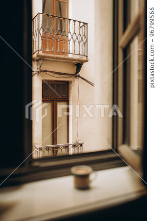 Coffee cup near the window with shutters in Turin, Italy. Coffee cup near the window with shutters in Turin, Italy. 96799568