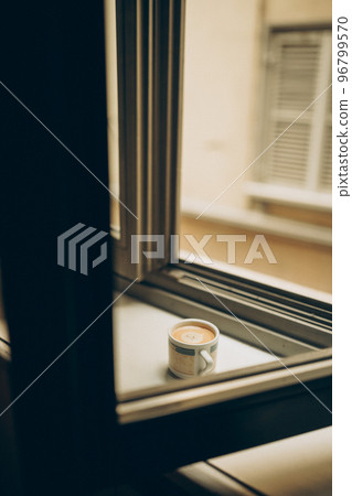 Coffee cup near the window with shutters in Turin, Italy. Coffee cup near the window with shutters in Turin, Italy. 96799570