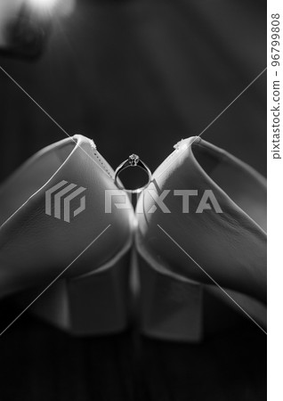 Ring with a stone on white women's leather shoes. Bride's accessories, bride's morning 96799808