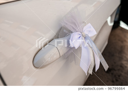 Car decoration for a wedding. Decorations on the car of the newlyweds. Cortege at the wedding Car decoration for a wedding. Decorations on the car of the newlyweds. Cortege at the wedding 96799864
