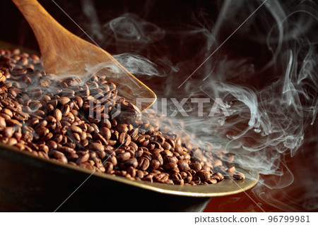 Coffee beans are smoky in a roasting pan. Coffee beans are smoky in a roasting pan. 96799981