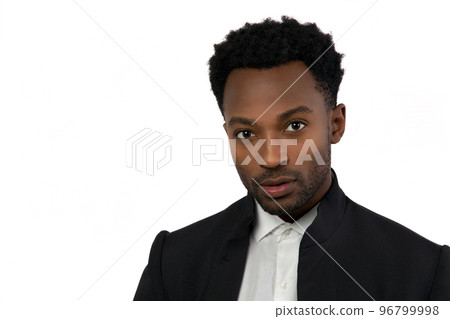 twenty year old man head shot suit style on white background studio portrait serious confident businessman 96799998