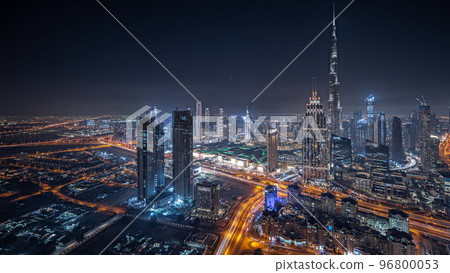 Panorama showing aerial view of tallest towers in Dubai Downtown skyline and highway night timelapse. Panorama showing aerial view of tallest towers in Dubai Downtown skyline and highway night timelapse. 96800053