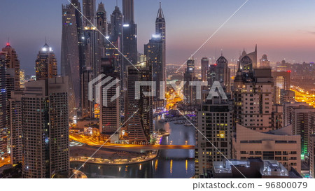 View of various skyscrapers in tallest recidential block in Dubai Marina aerial night to day timelapse View of various skyscrapers in tallest recidential block in Dubai Marina aerial night to day timelapse 96800079