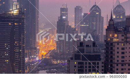 Dubai Marina and Media City districts with modern skyscrapers and office buildings aerial night to day timelapse. Dubai Marina and Media City districts with modern skyscrapers and office buildings aerial night to day timelapse. 96800080