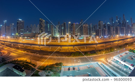 Panoraama of Dubai Marina skyscrapers and Sheikh Zayed road with metro railway aerial night to day timelapse, United Arab Emirates 96800093