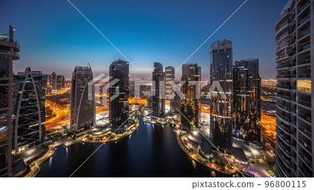 Tall residential buildings at JLT aerial night to day timelapse, part of the Dubai multi commodities centre mixed-use district. Tall residential buildings at JLT aerial night to day timelapse, part of the Dubai multi commodities centre mixed-use district. 96800115