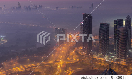 Big crossroad junction between JLT district and Dubai Marina intersected by Sheikh Zayed Road aerial night to day timelapse. 96800123