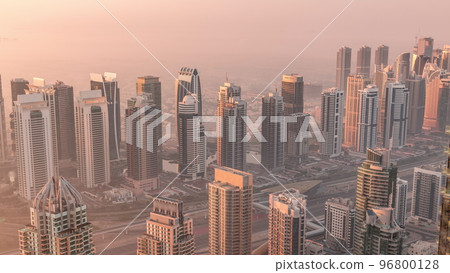 JLT skyscrapers and marina towers near Sheikh Zayed Road aerial timelapse during sunrise. Residential buildings 96800128