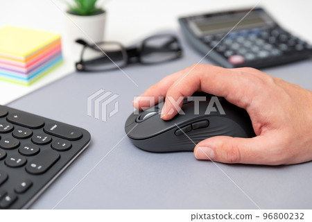 Man using computer mouse, office concept 96800232