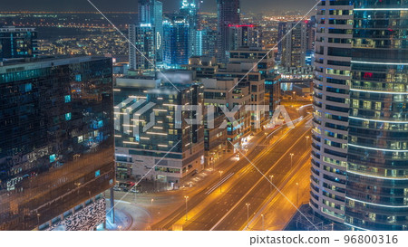 Dubai's business bay towers aerial night timelapse. Rooftop view of some skyscrapers 96800316