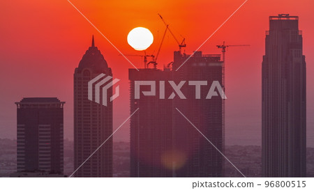 Skyline with modern architecture of Dubai business bay towers at sunset timelapse. Aerial view Skyline with modern architecture of Dubai business bay towers at sunset timelapse. Aerial view 96800515