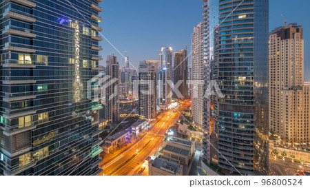 View of the Dubai Marina and JBR area and the famous Ferris Wheel aerial night to day timelapse 96800524