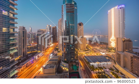 Panoramic view of the Dubai Marina and JBR area and the famous Ferris Wheel aerial night to day timelapse Panoramic view of the Dubai Marina and JBR area and the famous Ferris Wheel aerial night to day timelapse 96800525