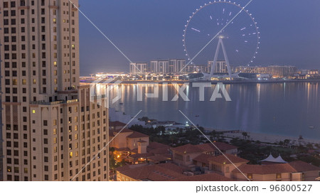 Bluewaters island with modern architecture and ferris wheel aerial night to day timelapse. Bluewaters island with modern architecture and ferris wheel aerial night to day timelapse. 96800527