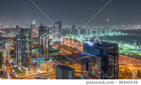 Moon rising over media city and al barsha heights district area night timelapse from Dubai marina. 96800548