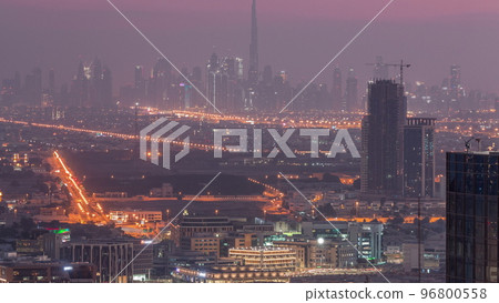 Dubai Downtown skyline row of skyscrapers with tallset tower aerial night to day timelapse. UAE 96800558