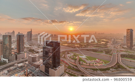 Sunrise over highway junction near media city and al barsha heights district area timelapse from Dubai marina. 96800559