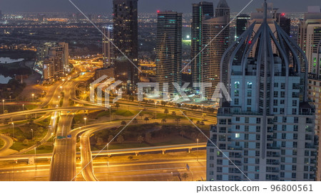 Huge highway crossroad junction between JLT district and Dubai Marina night to day timelapse. 96800561